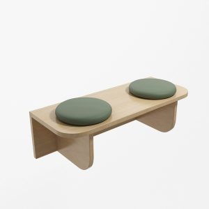 Modern commercial wood bench with two sage green upholstered cushions for cafe or lobby.